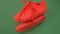 Pair of red sneakers hanging on green background. Orange boots hang out on the rope