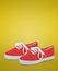 Pair of red unisex and kids sport shoes