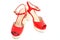 Pair of red womens high heeled patent shoes on white background.