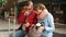 A pair of retired travelers reconcile their tickets with the train schedule using their smartphone. Modern mature couple