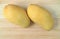 Pair of Ripe Ok-Rong Mangoes on wooden Background, Sweet and Fragrant Mango