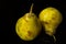 pair of ripe pears against a dark base and background