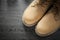 Pair of safety lace boots on wooden board