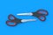 Pair of scissors on blue background. Barber equipment. Stationery accessories
