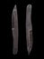 A pair of scratched steel throwing knives on black background