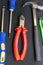 Pair of screwdrivers, nippers with red handles and a hammer manual tool locksmith vertical set