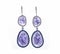 Pair of shiny purple earrings under the lights isolated on a white background