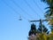 Pair of shoes hanging from electric wire against blue sky