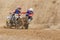 Pair of sidecar racers in dirty terrain