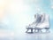 A pair of silver ice skates on a blurred light blue snowy background. Silver ice skates banner with copy space for text. Winter