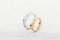Pair of silver mens ring and pink gold womens ring with diamonds  on white glitter background