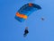 Pair of skydivers on a blue sky background. Tandem parachuting. Canopy in the sky