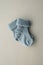 A pair of small baby, new born socks on wooden background.