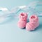 Pair of small baby socks on blue background with copy space for your warm message, baby shower, first newborn party background,