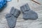 Pair of small woolen socks for newborn on wooden vintage table