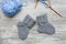 Pair of small woolen socks for newborn on wooden vintage table