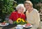 Pair of smiling women eating pie in cafe.