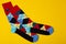 Pair of sock with a pattern of colored rhombuses, on a yellow background, fashion and lifestyle concept