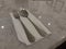 a pair of spoons and forks on a white tissue on a marble table. Sekective focus. Isolated background