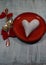 A pair of spoons with red ribbon and heart on a plate. Valentine\'s Day