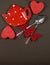 A pair of spoons with red ribbon and two hearts and red plate , Valentine\'s Day