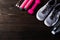 Pair sports shoes, headphones, dumbbell and water bottle on black wood table background