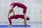 Pair sporty yoga women doing exercise on gray stylish background. Couple yoga pose