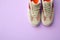 Pair of stylish shoes on lilac background. Space for text