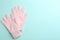 Pair of stylish woolen gloves on light blue background, flat lay. Space for text