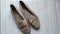 a pair of suede women shoe in cream color which is very dusty and dirty, top view photo angle