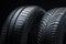 a pair of summer tires, side view, close-up on a black background