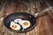 Pair Of Sunny Side Up Eggs Prepared In Old Heavy Duty Teflon Frying Pan Set On Old Cracked Flaky Garden Table