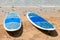 Pair of surfboards lie on a sandy beach