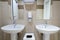 Pair of symmetrical sinks in a modern public toilet with paper towels and soap dishes
