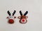 A pair of tiny reindeer decorations, Christmas and New Year holiday composition on white background, christmas decorations, Rudolf