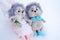 a pair of toy hedgehogs in wedding clothes on a white background,a holiday concept