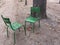 Pair of two empty garden chairs facing each other in Paris park