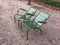 Pair of two empty garden chairs facing same directioin Paris park