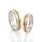 Pair of two tone gold wedding rings with wave design isolated on white background