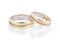 Pair of two tone gold wedding rings with wave design isolated on white background