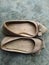 A pair of used cream colored women\\\'s shoes.