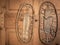 A pair of very old snowshoes hanging on a wooden wall
