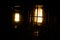 Pair of vintage electrical lamps lighting up in dark room