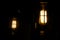 Pair of vintage electrical lamps lighting up in dark room