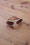 Pair of vintage woman sunglasses with white frames, rhinestones, centered, neutral wood background