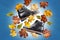 A pair of warm autumn black leather womens boots on blue background with bunch of autumn leaves