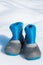 Pair of waterproof children boots on the snow