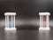 A pair of white hourglasses with blue and red sand, showing the last second or minute. the concept of passing time. With