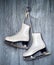 Pair of White Ice Skates on wooden backround