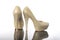 Pair of white pearls and lacy high pointed heels platform bridal shoes